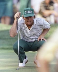 a man kneeling down holding a golf club