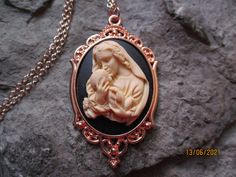 "Wonderful look for Easter and Christmas!! Beautiful Virgin Mary kissing baby Jesus cameo necklaces, choose black, pink, or blue background. The cameos are gorgeous. I do have many other colors, finishes and styles, so please do browse, I can make any larger cameo in my shop into this pretty necklace, so browse and message me with a custom order The pretty setting is classically beautiful rose gold tone, which measures about 2 1/2\" long. The chain is a matching 24\" rose gold link chain with a Black Cameo Necklace For Gift, Black Cameo Necklace Gift, Black Cameo Necklace As A Gift, Handmade Black Jewelry For Mother's Day, Blue Virgin Mary, Mary Jewelry, Cameo Pendant Necklace, Easter Religious, Pretty Necklace