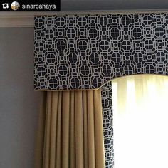 the curtains are hanging in front of the window with black and white designs on them