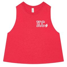 Kansas City Crop Top | Football Crop Top | Football Shirt Women | Tailgate Crop Top | Kansas City Shirt | Kansas City Football the women's flowy racerback crop tank brand: bella canvas 52/48 airlume combed + ring-spun cotton/polyester jersey athletic heather is 90/10 airlume combed + ring-spun cotton/polyester jersey relaxed, cropped fit. raw edge, elongated armholes. true to size crop. custom created by hand just for you with high quality vinyl please note colors may vary by computer monitor ha Pre-shrunk Fitted Tops For Sports Events, Fitted Pre-shrunk Tops For Sports Events, Custom Print Fitted Tops For Sports Events, Fitted Custom Print Tops For Sports Events, Fitted Tops With Custom Print For Sports Events, Red Tops With Custom Print For Sports Events, Football Shirt Women, Football Crop Top, Kansas City Football