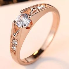 a close up of a diamond ring on a table