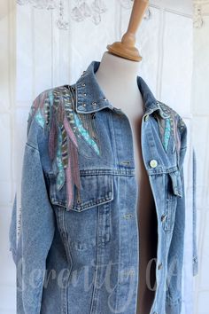 a denim jacket with colorful feathers on it