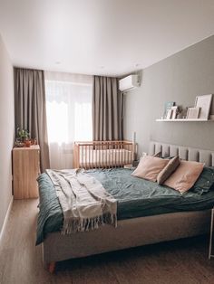 a large bed in a bedroom next to a window