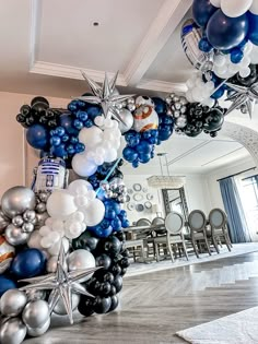 a star wars balloon arch in the middle of a living room filled with balloons and stars