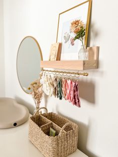 there is a basket on the counter next to a mirror