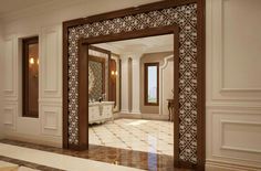 an ornate mirror in the middle of a room with marble flooring and white walls