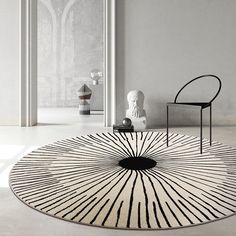 a black and white rug in the middle of a room with a chair on it