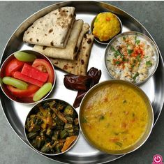 a metal plate topped with different types of food