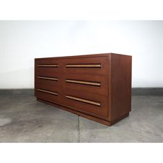 a large wooden dresser sitting on top of a cement floor