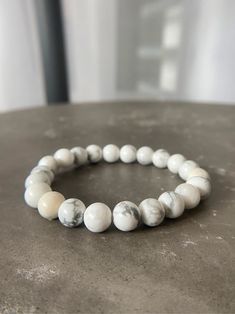 Howlite is a stone of awareness. It can help you to remain calm and centered in times of stress or chaos. Howlite also aids in the development of patience, tolerance, and understanding. Wearing a howlite bracelet can help you to stay connected to the peace and tranquility that resides within you. White Adjustable Holistic Bracelet, Adjustable White Holistic Bracelets, White Holistic Adjustable Bracelets, White Minimalist Crystal Bracelet For Everyday, Minimalist White Crystal Bracelet For Everyday, White Howlite Spiritual Bracelets, Spiritual Hand-strung Howlite Bracelets, Spiritual White Howlite Beaded Bracelets, White Gemstone Beads Stretch Bracelet For Meditation