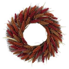 a dried wreath with red and brown flowers