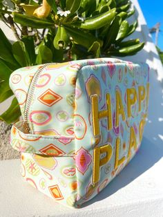 the cutest nylon Happy Place bag to keep all your accessories dry while having fun in the sun! This print is perfect for summer + a green stripe interior! Patches are yellow + sewn on, ships immediately! Pair it with our Vacay L or Beach Clear pouch bag for a set! Beautiful artwork in collaboration with Fete Papier! Dimensions: 26*8.5*14cm Playful Bags For Spring Playtime, Playful Green Bags For Vacation, Playful Green Vacation Bags, Fun Green Bags For Vacation, Summer Vacation Bags With Zipper Pouch, Summer Vacation Bag With Zipper Pouch, Playful Travel Bags For Beach Season, Green Poolside Bags For Beach Season, Green Zipper Pouch Bag For Summer