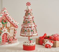 gingerbread houses and christmas gifts on a table