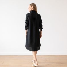 Washed Linen Shirt Dress in Black. Linen clothing for women in various colors. A Shape silhouette, long sleeves, knee length. Camilla With a fluid, drapey silhouette and long sleeves, our Camilla linendress is versatile, comfortable and effortlessly stylish. Thanks to the understated gathered detailing to the cuffs and back, delicate buttons and two handy pockets, this linen dress works as beautifully on a summer picnic as in the office. Available in Black, Graphite, Marine Blue, Sea Blue, Indig Black Linen Clothing, Shape Silhouette, Camilla Dress, Linen Clothing, Linen Shirt Dress, Marine Blue, Sea Blue, Summer Picnic, Black Linen