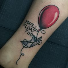 a red balloon with the words you'll float too on it and an origami plane