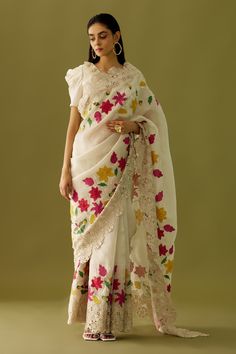 Ivory organza saree with multi colored floral embroidered appliques and cutwork hem. Comes with matching chanderi blouse  piece.
Component: 1
Pattern: Embroidered
Type Of Work: Floral Appliques
Fabric: Organza, Chanderi
Color: Ivory
Other Details: 
Cutwork detailing
Note: The blouse worn by the model is not for sale
Occasion: Destination Wedding - Aza Fashions Cutwork Saree, Alaska Fashion, Heavy Embroidery, Organza Saree, Work Sarees, Sequins Embroidery, Silk Organza, Thread Work, Bollywood Saree