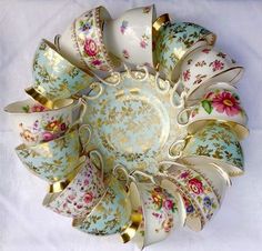 an ornately decorated bowl with gold trimmings and flowers on it's sides