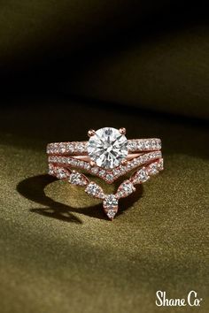 a close up of a diamond ring on a green cloth