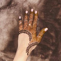 a woman's hand with henna on it