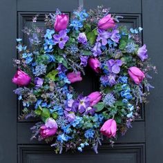 a wreath with purple and blue flowers on it