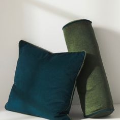 two green pillows sitting next to each other