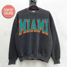 "comfort colors Miami Football sweatshirt, Miami Football Shirt, Miami Football Gift, Miami Sunday Football -Please check Color and Size Charts before placing the order. You can find them in the listing's photos (Depending on what device you are viewing this listing colors may vary slightly). -Returns and exchanges are accepted only if there are defects \"No Extra Costs\" We create custom t-shirts with great designs for everyone's liking. If you don't find the size or color you would like, please message us and we will be happy to  accommodate! comfort colors Miami Football sweatshirt, Miami Football Shirt, Miami Football Gift, Miami Sunday Football PRODUCT Sweatshirt Comfort Colors® 1566     80% ring-spun cotton, 20% polyester     Medium-heavy fabric (9.5 oz /yd² (322.1 g/m     Relaxed fi Casual Letter Print Sweatshirt For Game Day, Oversized Casual Sweatshirt, Casual College Sweatshirt With Screen Print, Casual Sweatshirt With Text Print For Game Day, Casual Soft-washed Sweatshirt For College, Casual Gray Sweatshirt For Game Day, Oversized Fan Apparel Sweatshirt For College, Oversized Cotton Sweatshirt Fan Apparel, Casual Text Print Sweatshirt For Game Day