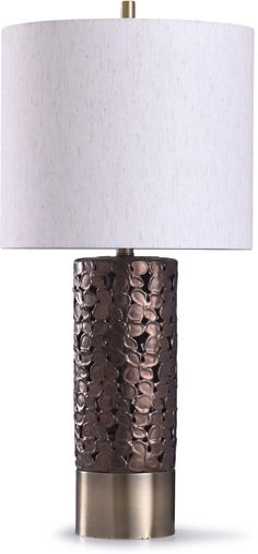 a table lamp with a white shade on the top and a silver base, in front of a white background