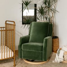 a baby crib and rocking chair in a room with potted plants on the wall