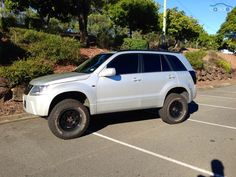 a white suv parked in a parking lot