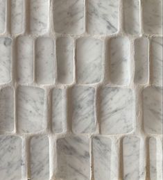 the white marble tiles are arranged in rows