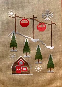 a cross stitch pattern with trees and houses