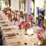 a long table is set up with place settings and centerpieces for an event