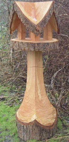 a bird house made out of wood in the woods