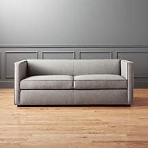 a couch sitting on top of a hard wood floor