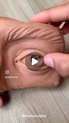 someone is painting the face of an animal's head with brown paint on it