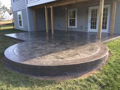 an outdoor patio with concrete steps leading up to the front door