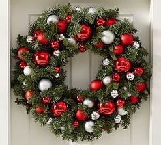 a christmas wreath with red and white ornaments