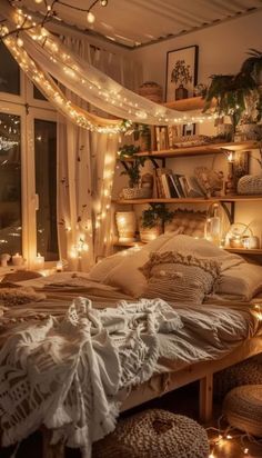 a bedroom with lights strung from the ceiling and bookshelves on shelves above it