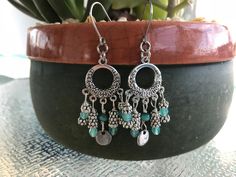 This beautiful pair of boho style dangle earrings is made with aqua Czech glass beads and silver daisy flower spacer beads. Boho earrings hang 2 inches from stainless steel earwire for the sensitive ears. Nickel-free Bohemian Beaded Earrings For Crafting, Bohemian Dangling Beads Drop Earrings, Bohemian Dangle Earrings For Jewelry Making, Silver Dangling Charms Earrings For Festival, Bohemian Style Crystal Drop Earrings With Dangling Beads, Silver Festival Earrings With Dangling Charms, Nickel-free Bohemian Chandelier Earrings, Bohemian Teardrop Crystal Earrings For Pierced Ears, Bohemian Teardrop Crystal Earrings