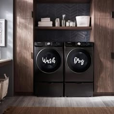 a washer and dryer in a room with wooden shelves on the wall behind them