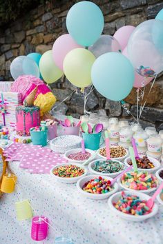 a table filled with lots of food and balloons