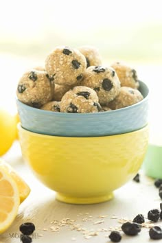 a yellow bowl filled with oatmeal and raisins on top of a table