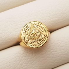 men's the Eye of Providence ring made in real 14k solid gold or real 18k solid gold the eye of Providence, ornaments and patterns are so exquisite. - the diameter of the top circle: 16.3mm on 9.0 US. the larger size, the bigger the diameter of the top - materials: real 14k solid gold, real 18k solid gold - free shipping on all orders via fedex! - designed by carre d'or - made in south korea 14k gold ring weight 4.0 - 4.5 US 3.23g (±3%) 5.0 - 6.0 US 4.44g (±3%) 6.5 - 7.0 US 5.26g (±3%) 7.5 - 8.0 US 6.17g (±3%) 8.5 - 9.5 US 7.23g (±3%) 10.0 - 10.5 US 8.36g (±3%) 11.0 - 12.0 US 9.59g (±3%) 12.5 - 13.0 US 10.22g (±3%) 18k gold ring weight 4.0 - 4.5 US 3.86g (±3%) 5.0 - 6.0 US 5.29g (±3%) 6.5 - 7.0 US 6.27g (±3%) 7.5 - 8.0 US 7.36g (±3%) 8.5 - 9.5 US 8.62g (±3%) 10.0 - 10.5 US 9.96g (±3%) 11.0 Engraved Gold Plated Signet Ring, Gold Symbolic Signet Ring, Yellow Gold Spiritual Signet Ring, Mens Ring Gold, Gold Ring Men, The Eye Of Providence, Eye Of Providence, Mens Gold Rings, Ring Mens