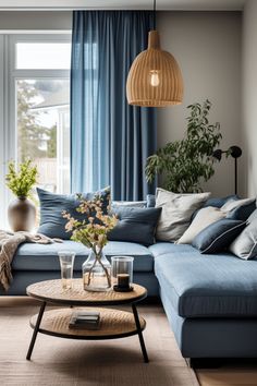 a living room filled with furniture and a large window covered in blue curtained drapes