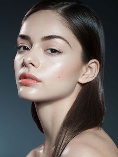 a woman with long brown hair and light makeup