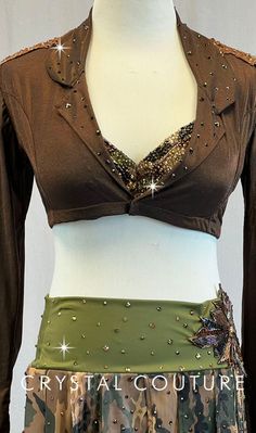 Military inspired 3 piece custom made costume. Bra-top is covered with sheer Camouflage mesh and is worn under a Brown stretch sheer cropped, long sleeved jacket. Camouflage Green lycra booty shorts with an attached piecy skirt made of Camouflage mesh on the front, reversing to various other complimentary fabrics. Embellishments include Swarovski rhinestones, embroidered lace appliques on the shoulders and a beaded and sequined applique at one hip. * Accessories include: hat WOW.....More than 18 gross Swarovski Enhanced Khaki 30ss, Khaki 20ss, Khaki 16ss, Khaki 12ss, Smoked Topaz 30ss, Smoked Topaz 20ss, Smoked Topaz 16ss, Light Colorado Topaz 30ss, Light Colorado Topaz 20ss, Light Colorado Topaz 16ss, Light Colorado Topaz 12ss, Jet 20ss, Jet 16ss, Jet Nut 34ss, Jet Nut 20ss and Jet Nut 16 Embellished Fitted Sets For Festival, Fitted Embellished Sets For Festivals, Elegant Fitted Festival Sets, Embellished Fitted Festival Sets, Brown Embroidered Festival Top, Camo Corset, Fitted Belly Dance Sets For Party, Camo Cropped Jacket, Trio Costumes