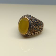 This empower ring is an awesome design bronze ring with an oval yellow Aqeeq. It is an awesome Masonic icon design bronze ring with a cabochon Yellow Aqeeq. It is an awesome design bronze ring. It has designed and made in Thailand. It is for the people who love to collect rare limited edition items and who wants to be different. This ring is one of a kind item for you. Material: Bronze The Main Stone: Yellow Aqeeq (Yellow Agate) Stone Color: Yellow Stone size: 10 x 14 mm. Ring weight approx.: 8 Yellow Agate, Bronze Ring, Yellow Stone, Ring For Men, Antique Design, Natural Blue Sapphire, Men's Ring, Size 10 Rings, Ring Vintage