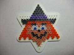 an ornament made out of plastic beads with a star as the focal point