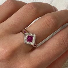 This Cocktail Ring Holds 4 Princess Cut Pink Rubies At The Center And 3 Tiny Rubies On Each Side Of The Shank. The Halo Is Set With Tiny Diamonds. This Unique Design Is Crafted In 14k White Gold With Ring Size 7. The Total Carat Weight Of Rubies Is 0.35cts And Diamonds Is 0.15cts. Comes With A Presentable Gift Box. Id: 031760 Luxury Pink Sapphire Ring With Pave Setting, Luxury Pink Sapphire Ruby Ring, Formal Pink Sapphire Ring With Pave Setting, Classic Ruby Ring With Pave Setting For Anniversary, Formal Ruby Ring With Pave Setting And Round Cut, Luxury White Gold Ruby Ring With Pave Setting, Luxury Sterling Silver Ruby Ring For Anniversary, Formal White Gold Ruby Ring With Pave Setting, Luxury Sterling Silver Ruby Ring