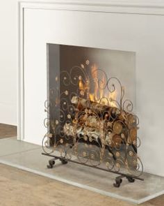 a fire place sitting on top of a hard wood floor next to a white wall